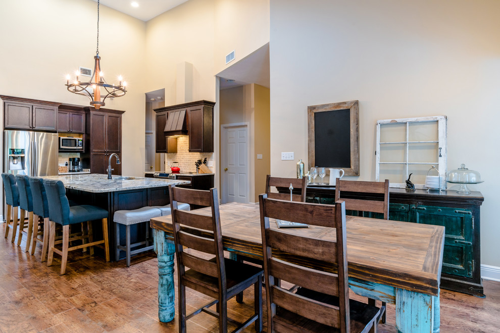 Inspiration for a large transitional l-shaped vinyl floor eat-in kitchen remodel in Miami with an undermount sink, shaker cabinets, dark wood cabinets, granite countertops, beige backsplash, porcelain backsplash, stainless steel appliances and an island
