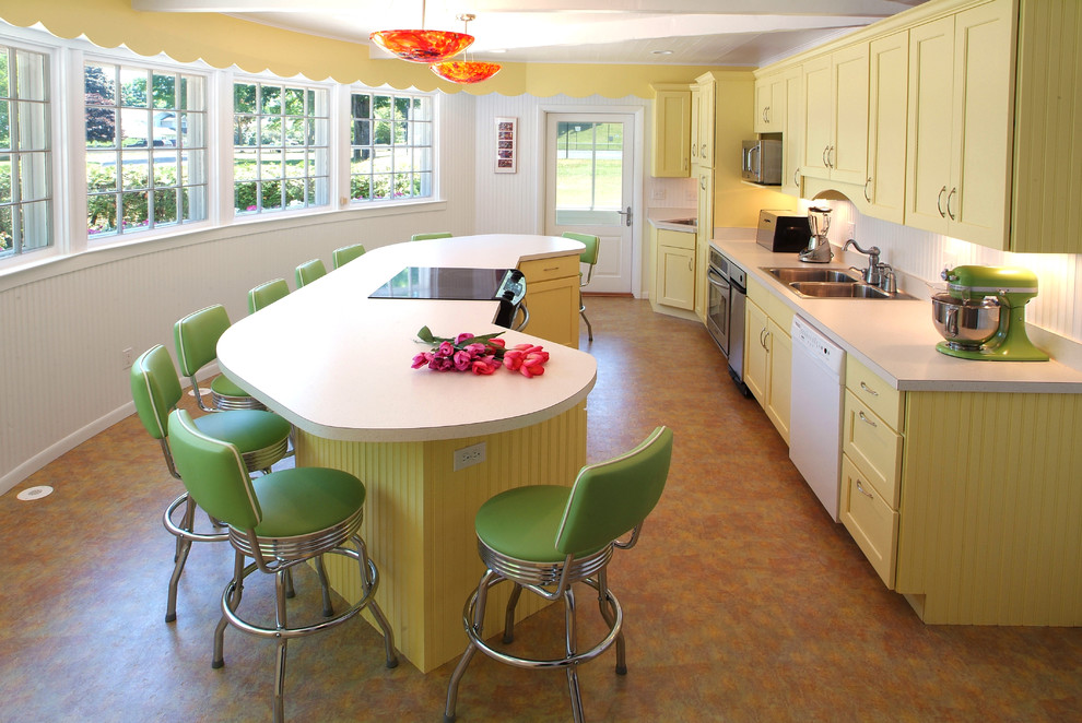 This is an example of a mid-sized traditional galley kitchen in Other with a drop-in sink, yellow cabinets, laminate benchtops and with island.