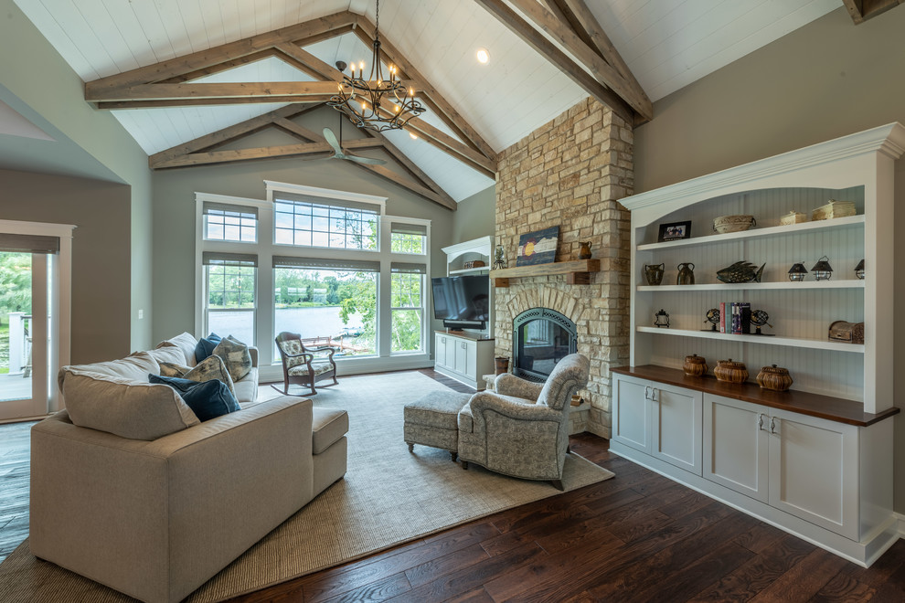 Mid-sized contemporary open concept living room in Milwaukee with beige walls, dark hardwood floors, a standard fireplace, a stone fireplace surround, a wall-mounted tv and brown floor.