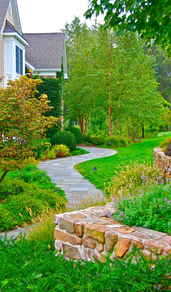 Design ideas for a large traditional side yard garden in New York with natural stone pavers.