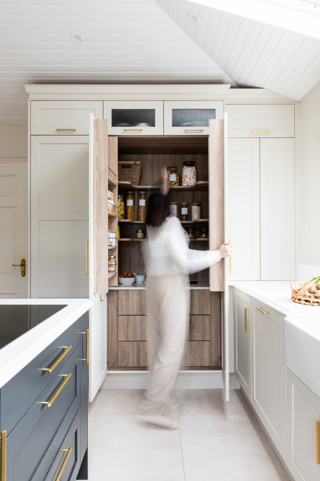Large contemporary u-shaped kitchen pantry in Other with a farmhouse sink, shaker cabinets, beige cabinets, granite benchtops, white splashback, granite splashback, black appliances, cement tiles, multiple islands, beige floor, white benchtop and vaulted.