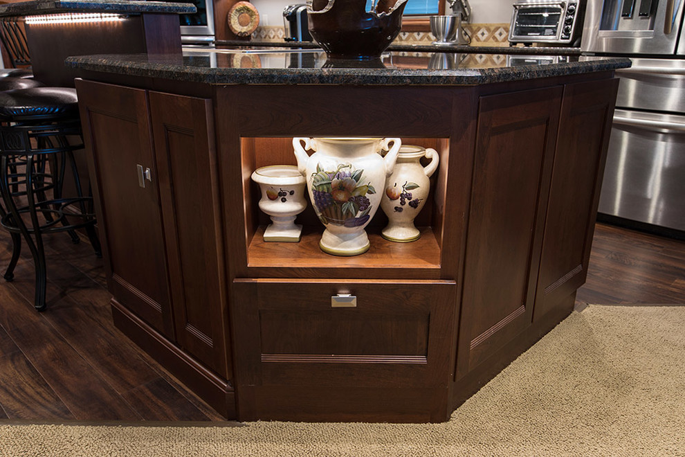 Eat-in kitchen - large transitional single-wall eat-in kitchen idea with an undermount sink, flat-panel cabinets, medium tone wood cabinets, stainless steel appliances and an island