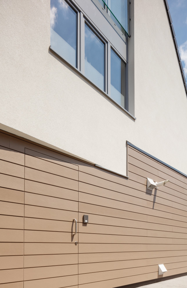 This is an example of a contemporary beige duplex exterior with concrete fiberboard siding.