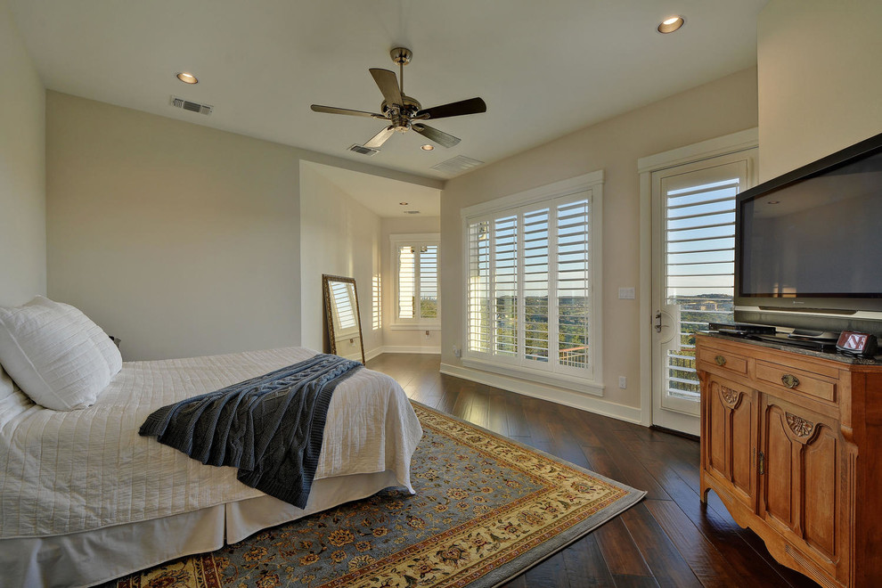Example of a large transitional master medium tone wood floor bedroom design in Austin with beige walls
