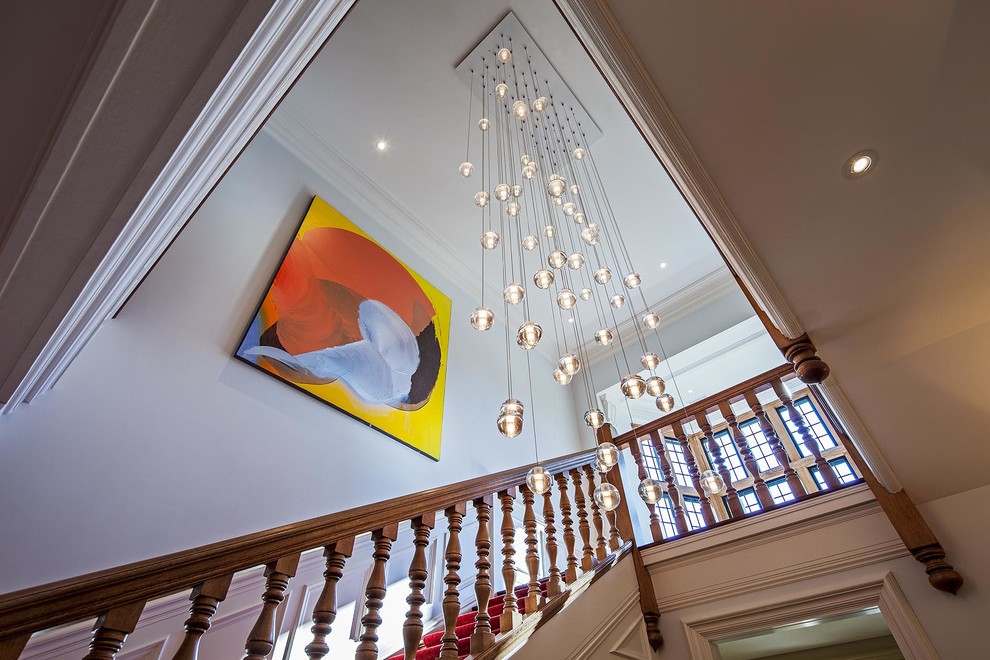 This is an example of an expansive eclectic wood u-shaped staircase in Toronto with wood risers and wood railing.