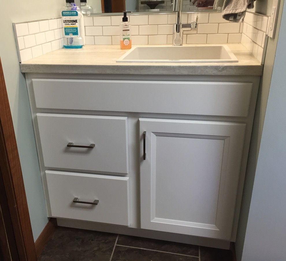 Example of a small transitional galley bathroom design with laminate countertops