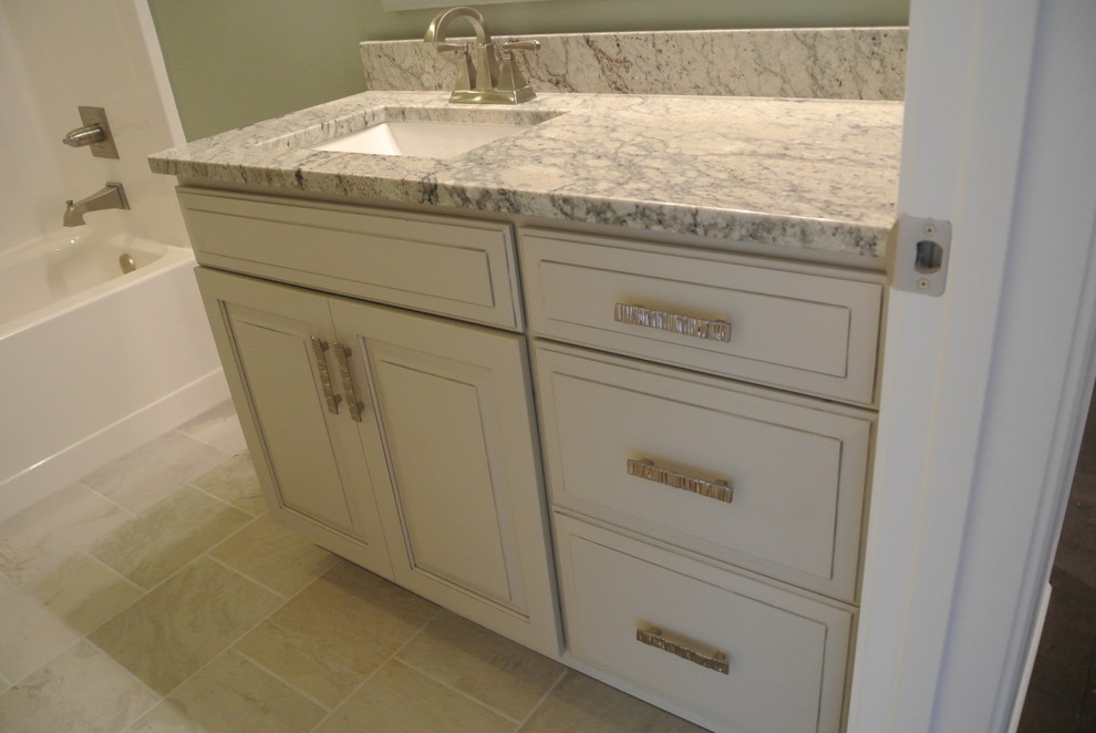 Inspiration for a transitional porcelain tile porcelain tile home design remodel with raised-panel cabinets and granite countertops