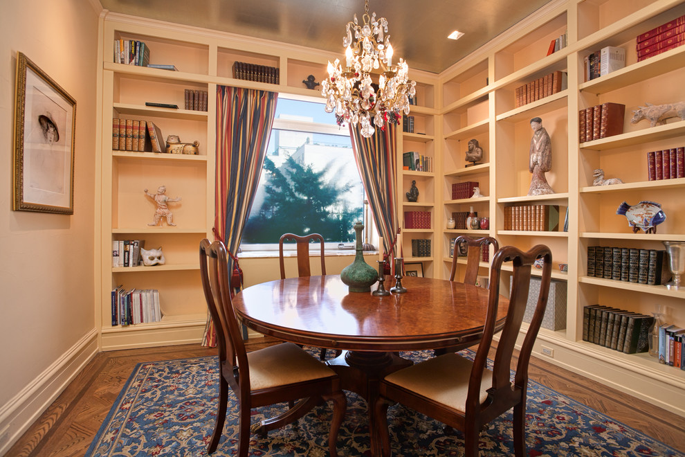 This is an example of a traditional dining room in New York with beige walls and dark hardwood floors.