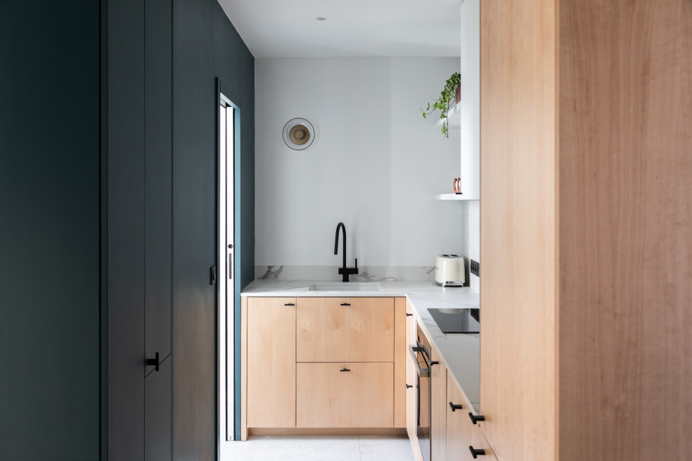 Design ideas for a mid-sized contemporary l-shaped separate kitchen in Paris with an undermount sink, beaded inset cabinets, light wood cabinets, quartz benchtops, white splashback, engineered quartz splashback, panelled appliances, ceramic floors, no island, white floor and white benchtop.