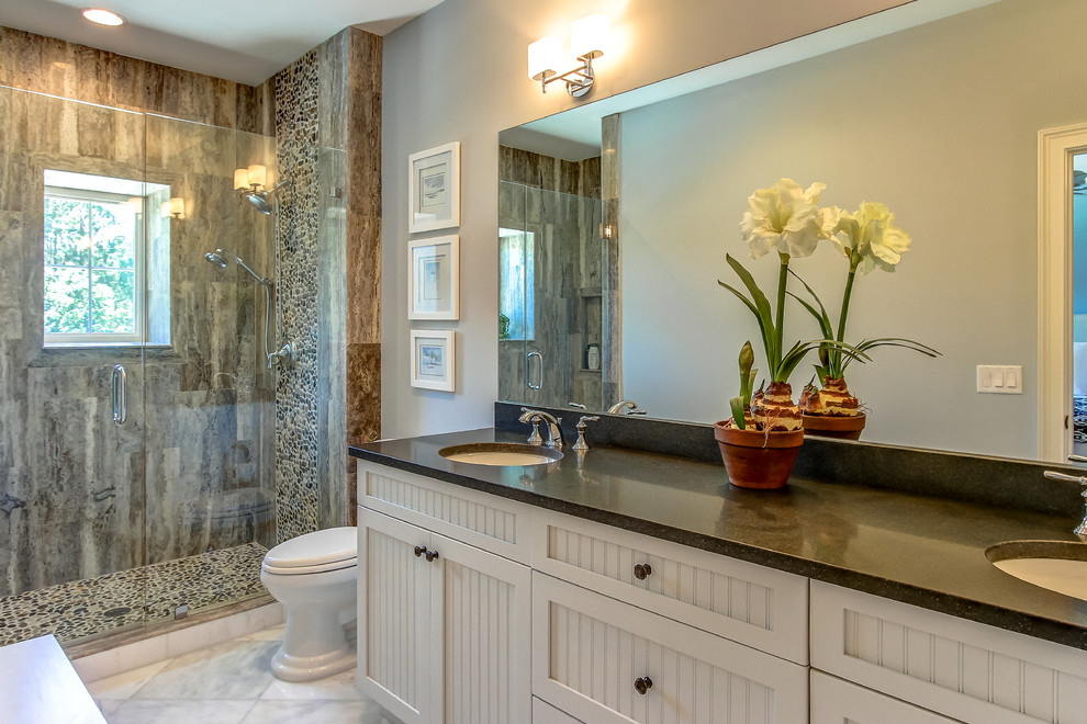 Example of a large transitional 3/4 beige tile, brown tile, gray tile and stone tile marble floor alcove shower design in Orange County with shaker cabinets, white cabinets, a one-piece toilet, gray walls, an undermount sink and solid surface countertops