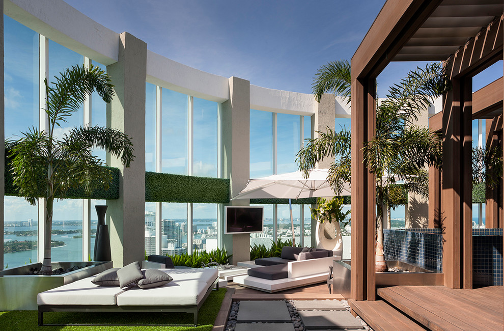 Photo of a large contemporary rooftop deck in Miami with a pergola.