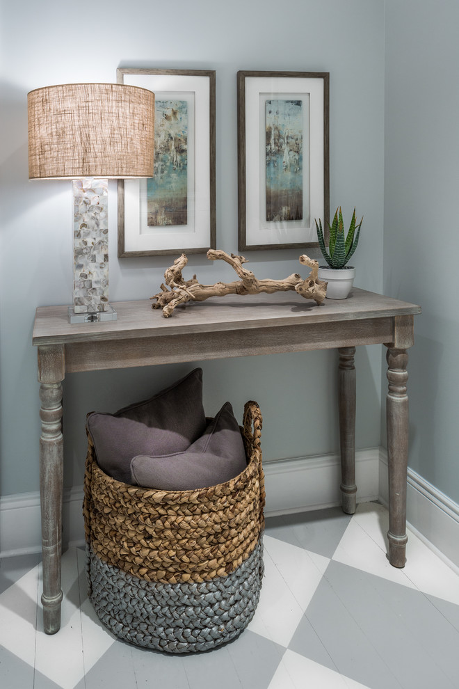 This is an example of a small beach style foyer in Phoenix with grey walls and painted wood floors.