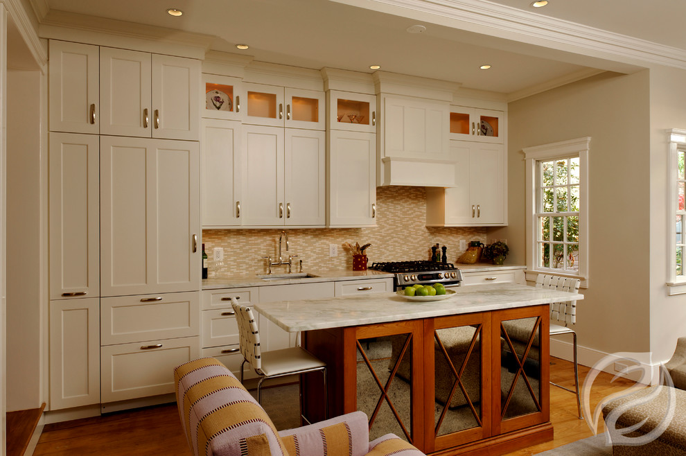 Inspiration for a small transitional single-wall light wood floor eat-in kitchen remodel in Chicago with an undermount sink, recessed-panel cabinets, white cabinets, marble countertops, multicolored backsplash, stone tile backsplash, paneled appliances and an island