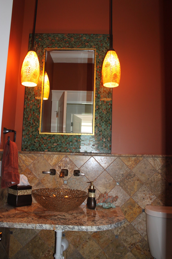 Small transitional black tile and stone tile slate floor bathroom photo with a two-piece toilet, orange walls, granite countertops and a vessel sink