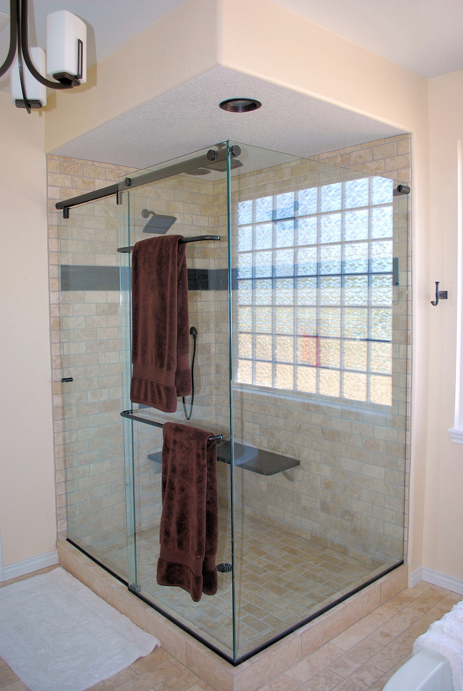 Inspiration for a large rustic master beige tile and subway tile beige floor and travertine floor freestanding bathtub remodel in Denver with shaker cabinets, dark wood cabinets, beige walls, an undermount sink, marble countertops and a hinged shower door