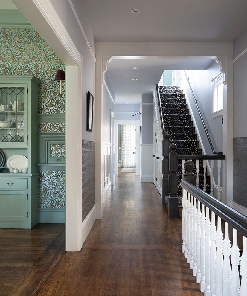 Large traditional hallway in San Francisco with multi-coloured walls, dark hardwood floors and brown floor.
