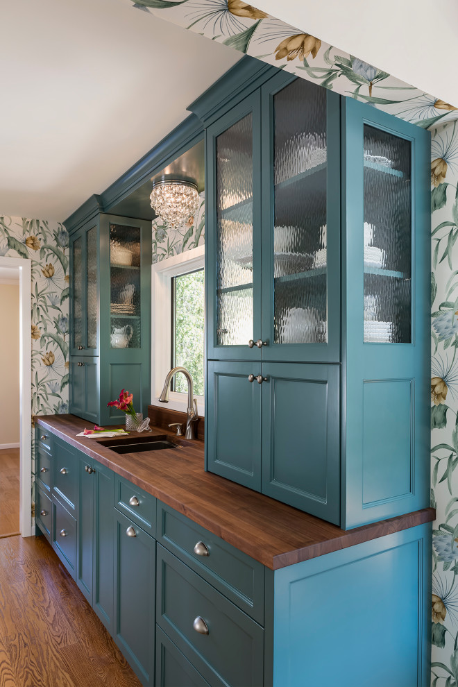 Mid-sized traditional single-wall wet bar in Minneapolis with an undermount sink, recessed-panel cabinets, green cabinets, wood benchtops, medium hardwood floors, brown floor and brown benchtop.