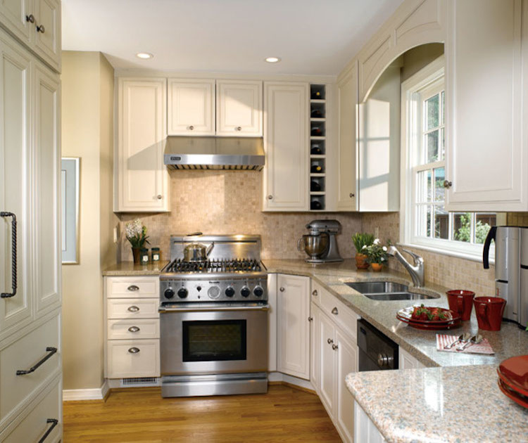 Eat-in kitchen - mid-sized transitional l-shaped dark wood floor and brown floor eat-in kitchen idea in Orange County with an undermount sink, recessed-panel cabinets, white cabinets, granite countertops, beige backsplash, ceramic backsplash, stainless steel appliances and an island