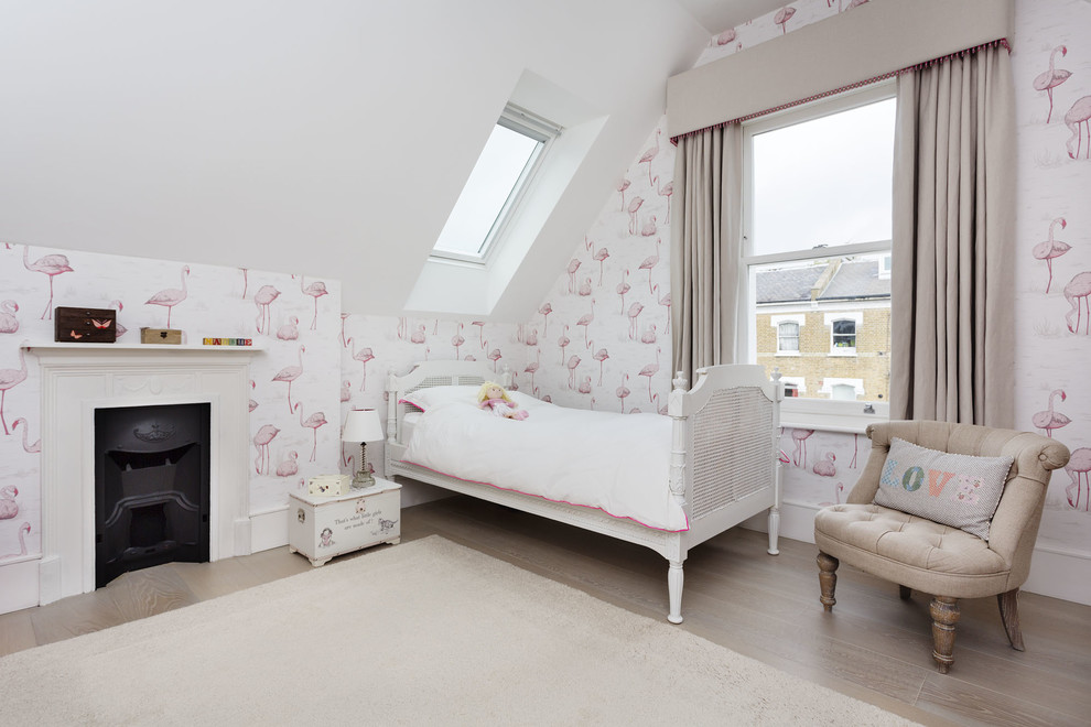 Mid-sized traditional kids' bedroom in London with medium hardwood floors for kids 4-10 years old and girls.