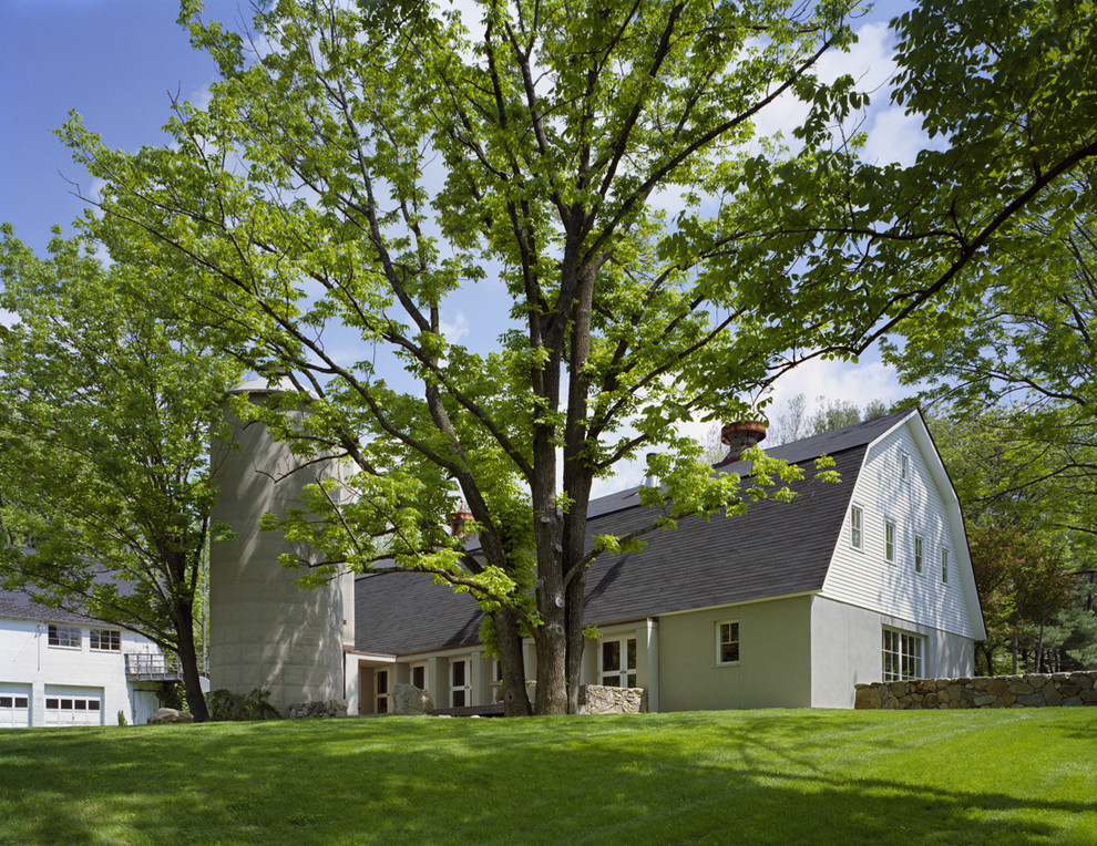 Photo of a large country exterior in New York with a gambrel roof.