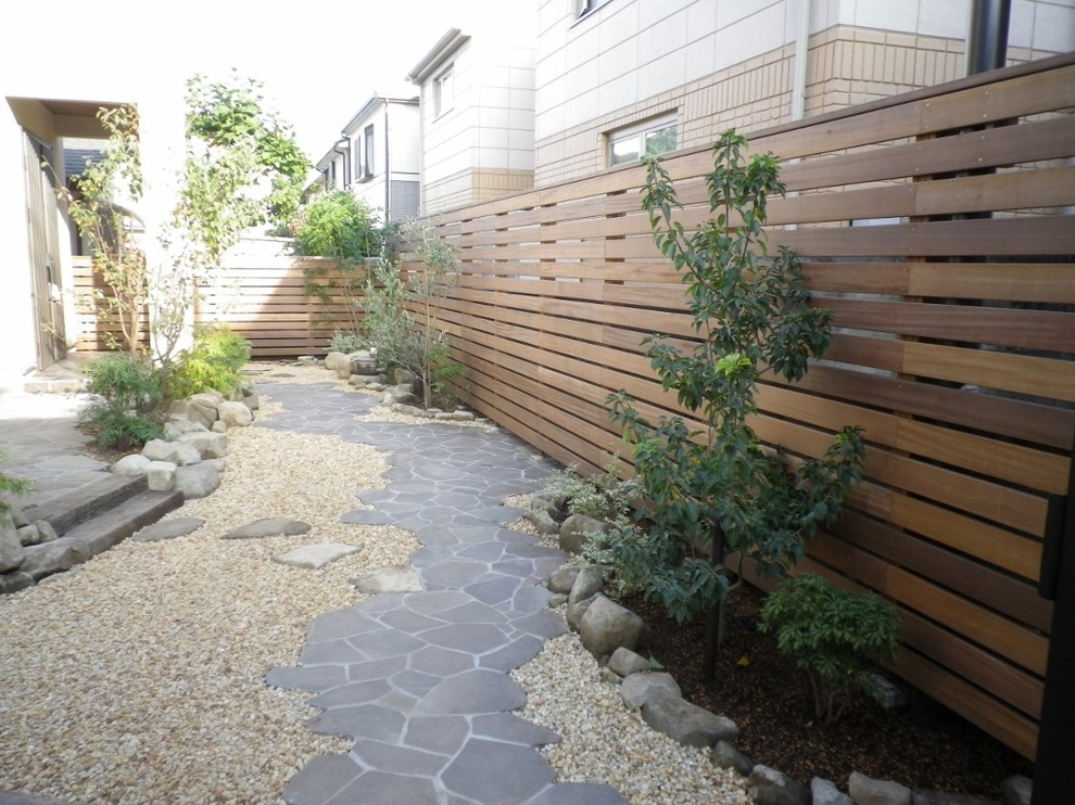 Design ideas for an asian front yard patio in Tokyo with natural stone pavers.