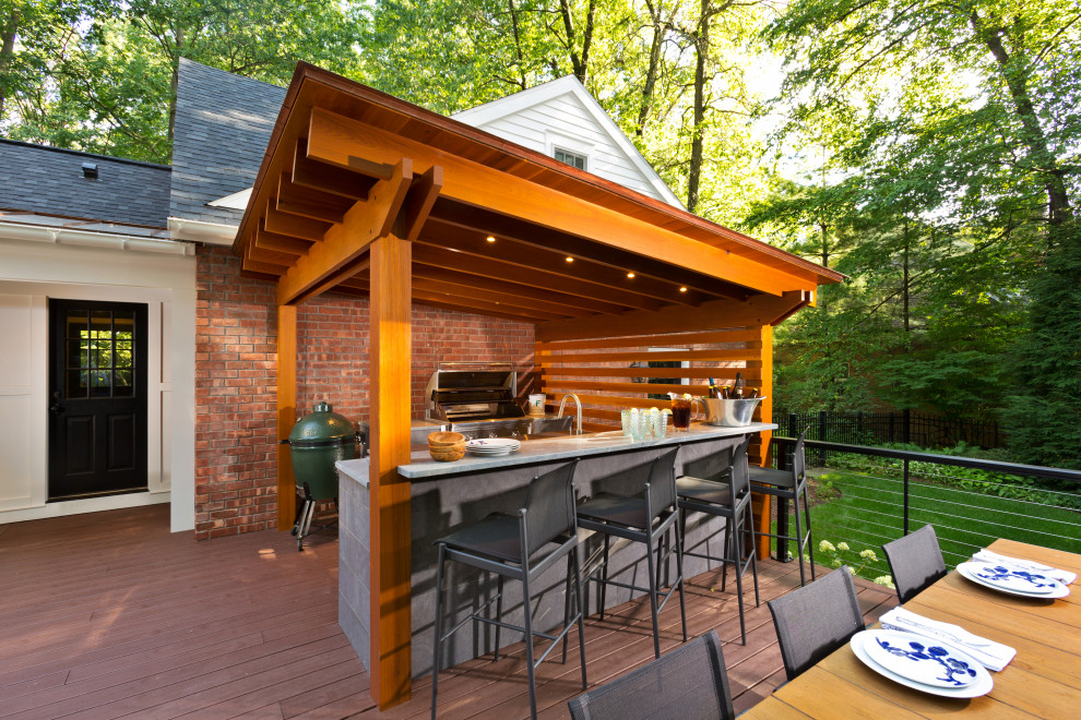 Photo of an expansive traditional backyard deck in Boston with an outdoor kitchen and a pergola.
