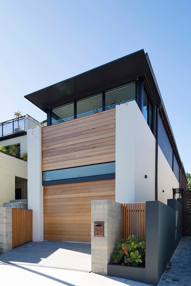 This is an example of a modern two-storey house exterior in Sydney with wood siding.