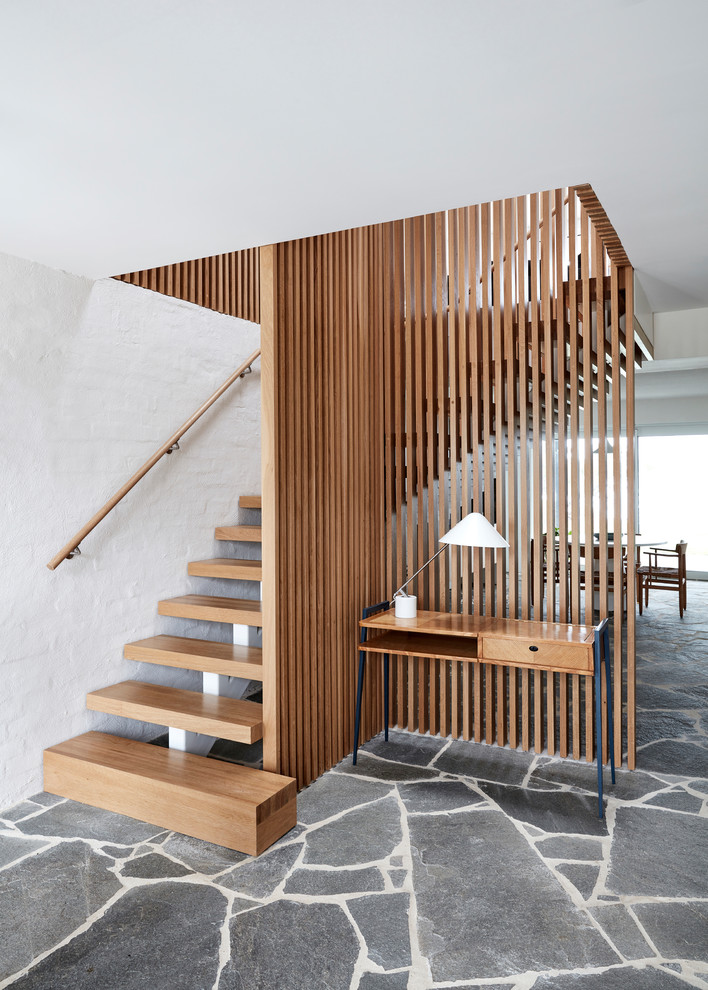 Inspiration for a midcentury wood l-shaped staircase in Los Angeles with open risers and wood railing.