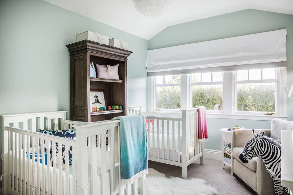 Photo of a traditional gender-neutral nursery in San Francisco with green walls, carpet and grey floor.