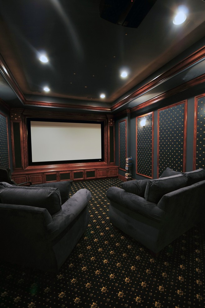 Inspiration for a small traditional enclosed home theatre in Chicago with black walls, carpet and a projector screen.