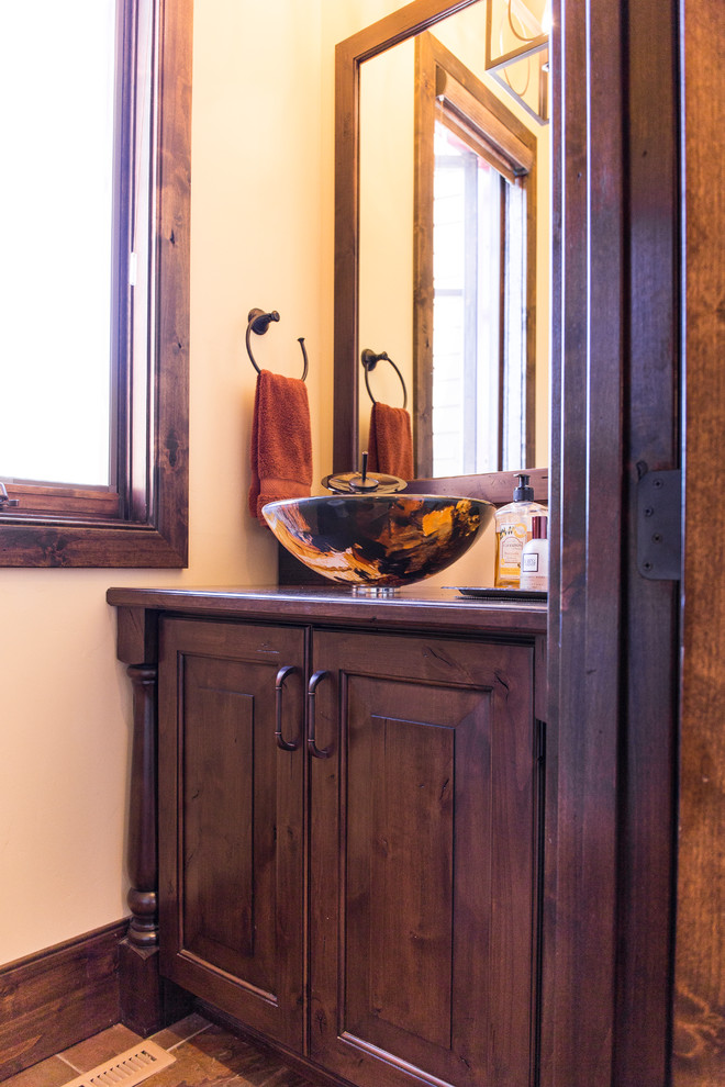Mid-sized powder room in Salt Lake City with raised-panel cabinets and dark wood cabinets.