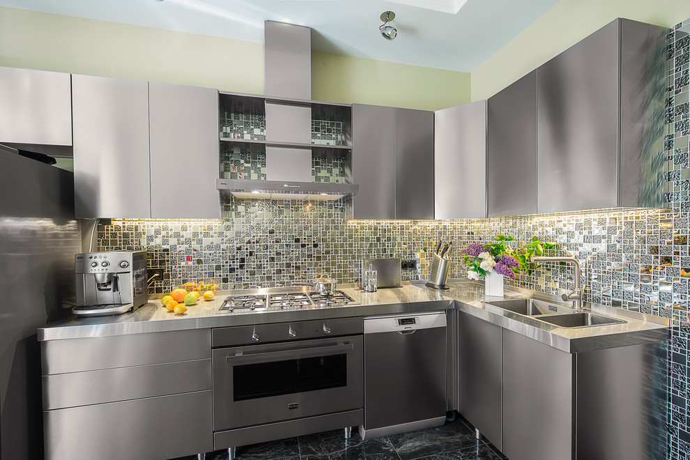 Design ideas for a contemporary l-shaped separate kitchen in Moscow with a double-bowl sink, flat-panel cabinets, stainless steel cabinets, stainless steel benchtops, grey splashback, no island, stainless steel appliances and black floor.