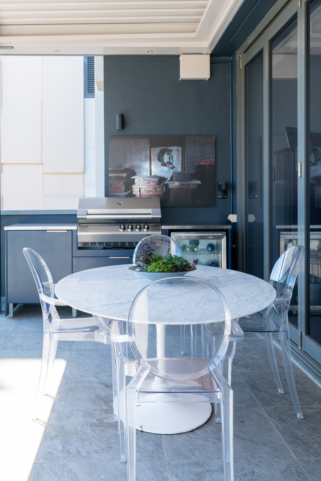 Photo of a small contemporary balcony in Sydney with a pergola and glass railing.
