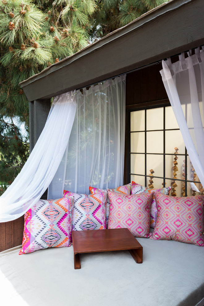 Inspiration for a mid-sized beach style backyard patio in Los Angeles with a roof extension.