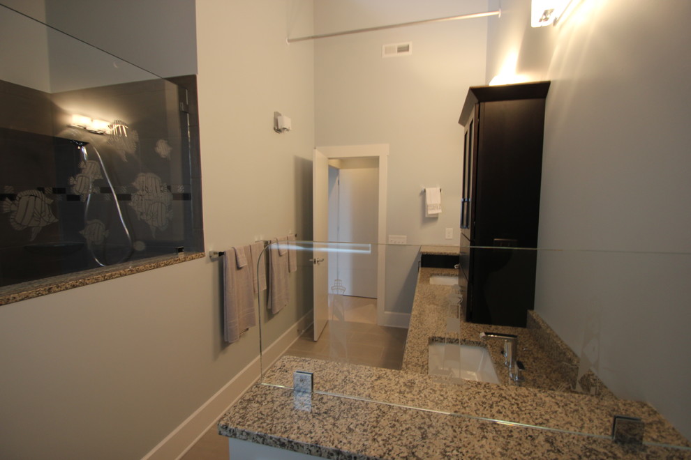 Inspiration for a coastal gray tile and porcelain tile walk-in shower remodel with an undermount sink, shaker cabinets, stainless steel cabinets, granite countertops and a two-piece toilet