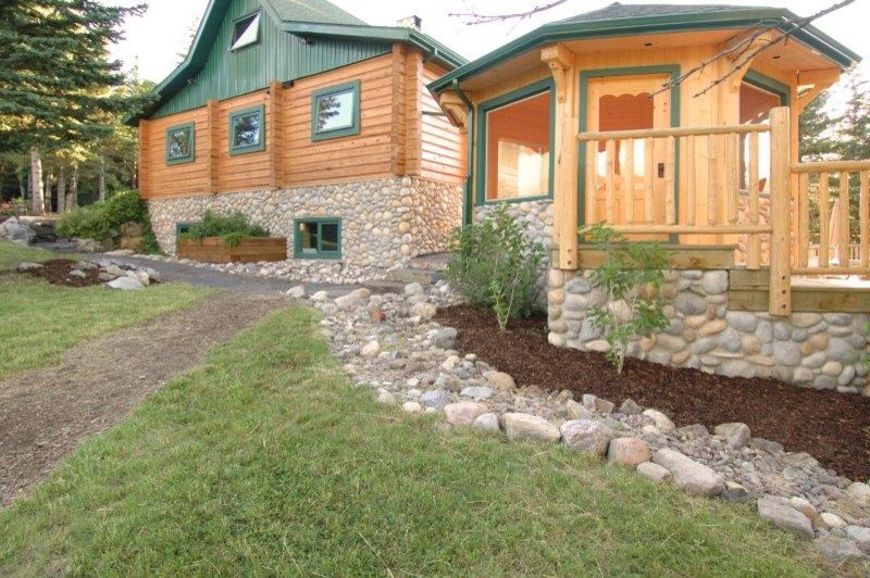 Inspiration for a mid-sized rustic partial sun side yard stone driveway in Calgary.