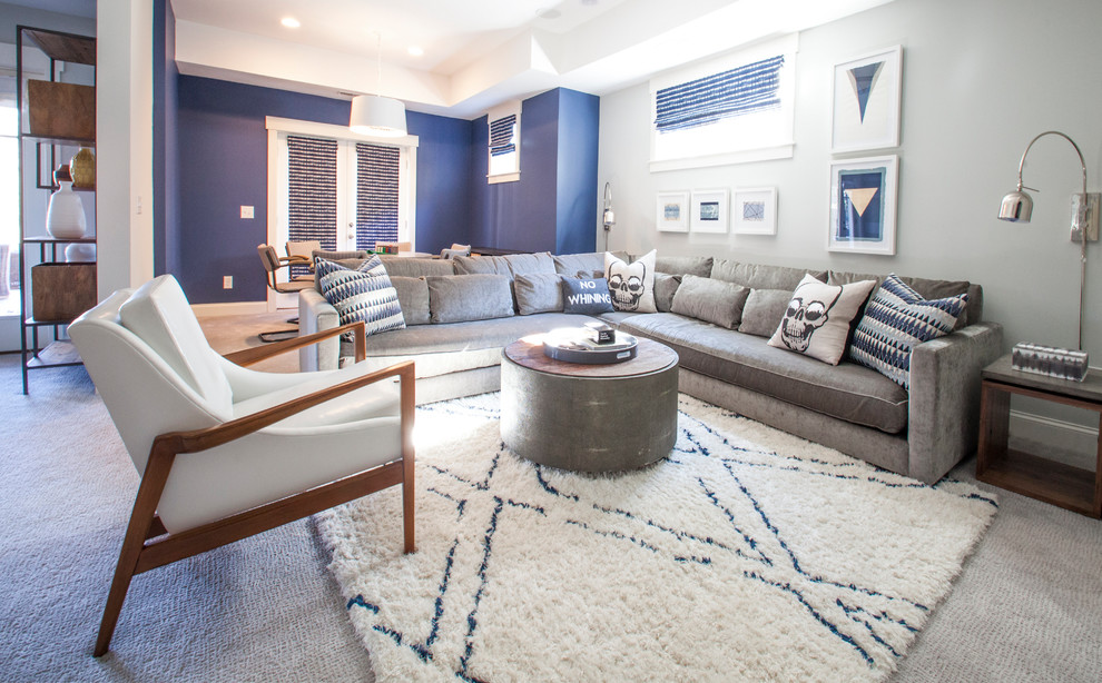 Transitional open concept living room in Charlotte with blue walls, carpet and grey floor.