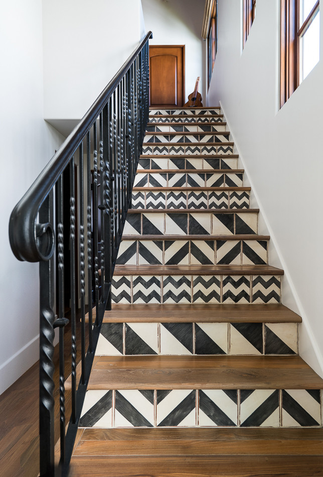 This is an example of a small beach style wood straight staircase in Orange County with tiled risers.