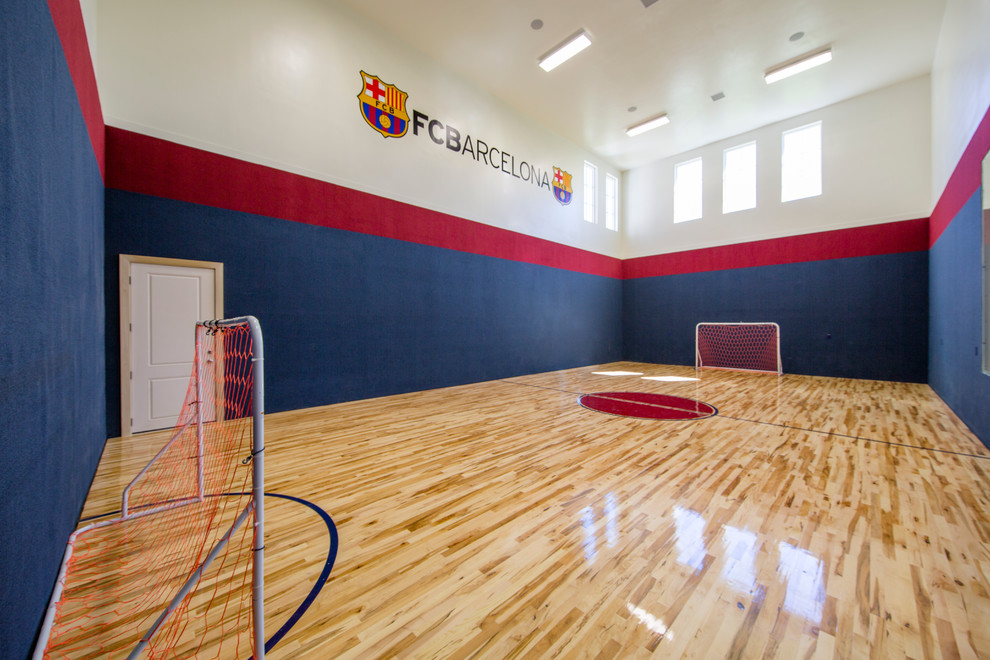 Inspiration for a large traditional indoor sport court in Salt Lake City with multi-coloured walls and light hardwood floors.