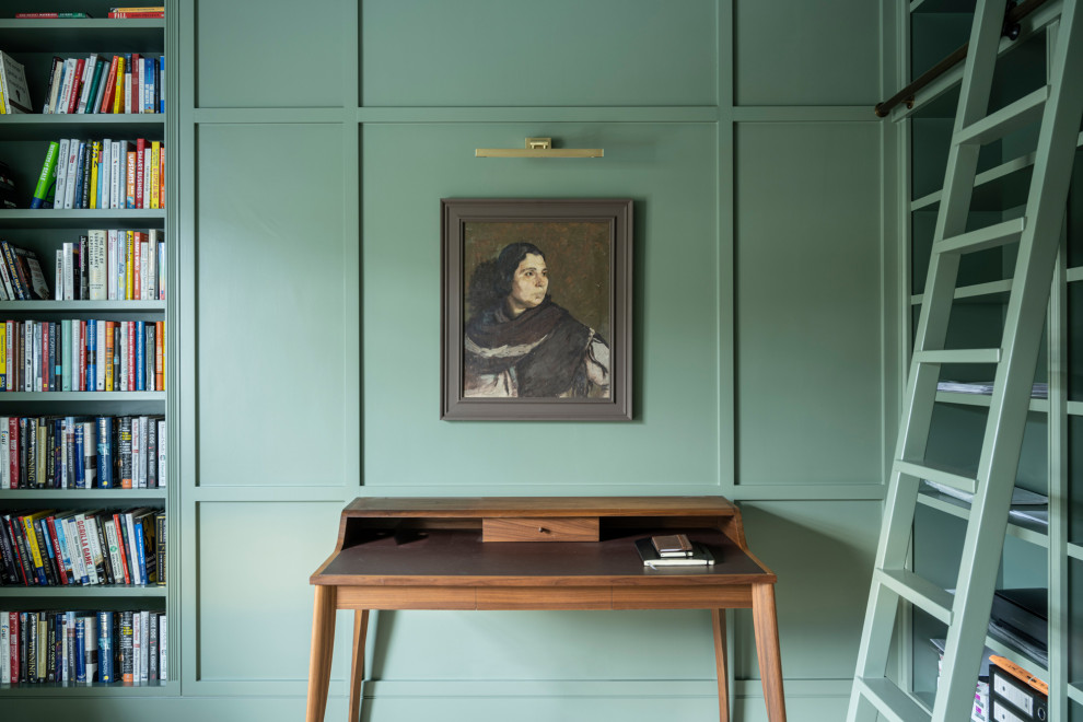 Large traditional home office in London with green walls and panelled walls.