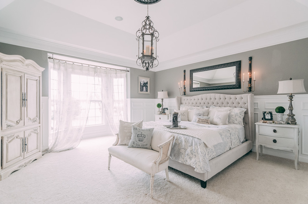 Large traditional master bedroom in Nashville with grey walls, carpet, white floor and no fireplace.