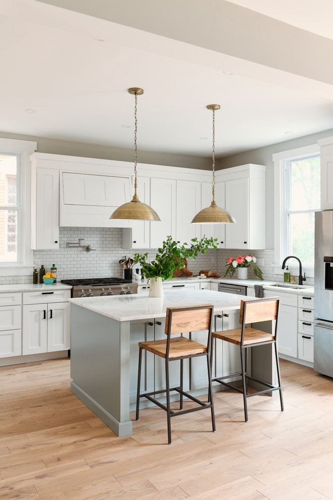 Mid-sized contemporary l-shaped eat-in kitchen in Other with shaker cabinets, white cabinets, quartzite benchtops, with island and white benchtop.