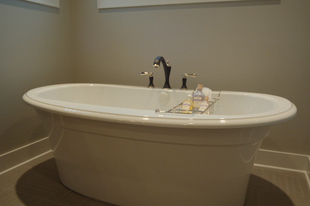 Mid-sized transitional master gray tile and porcelain tile porcelain tile freestanding bathtub photo with an undermount sink, furniture-like cabinets, dark wood cabinets, quartzite countertops, a two-piece toilet and gray walls