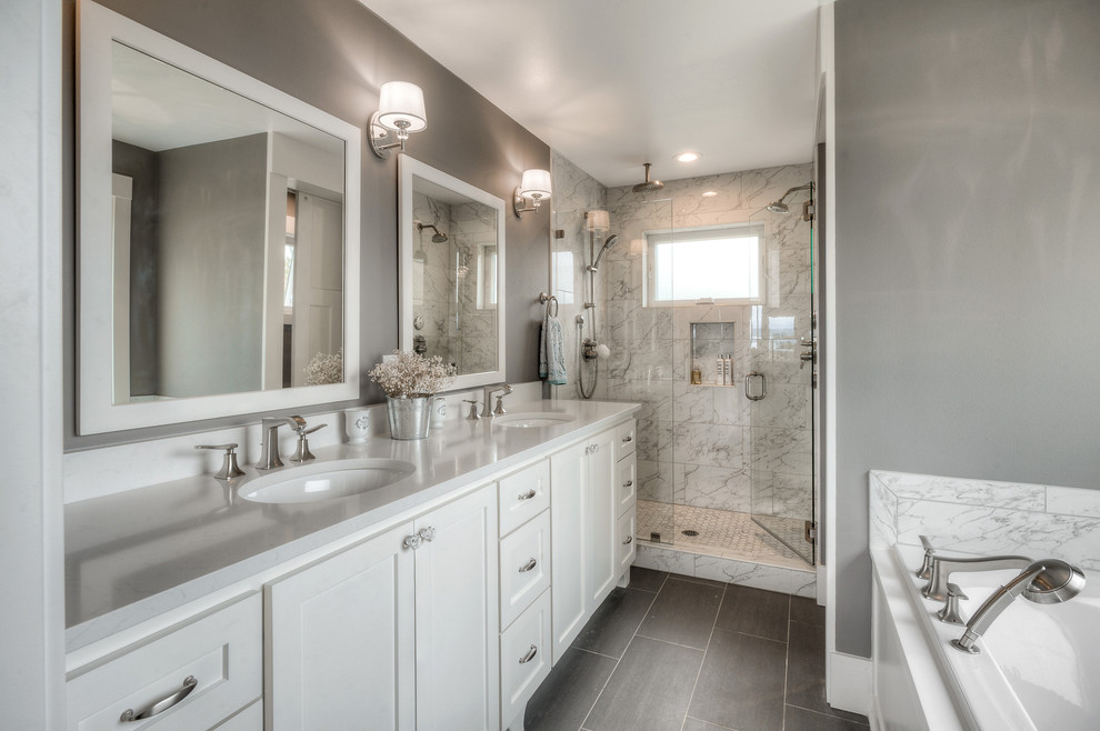 This is an example of a mid-sized traditional master bathroom in Seattle with shaker cabinets, white cabinets, a drop-in tub, a double shower, a two-piece toilet, gray tile, porcelain tile, grey walls, porcelain floors, an undermount sink, engineered quartz benchtops, grey floor and a hinged shower door.