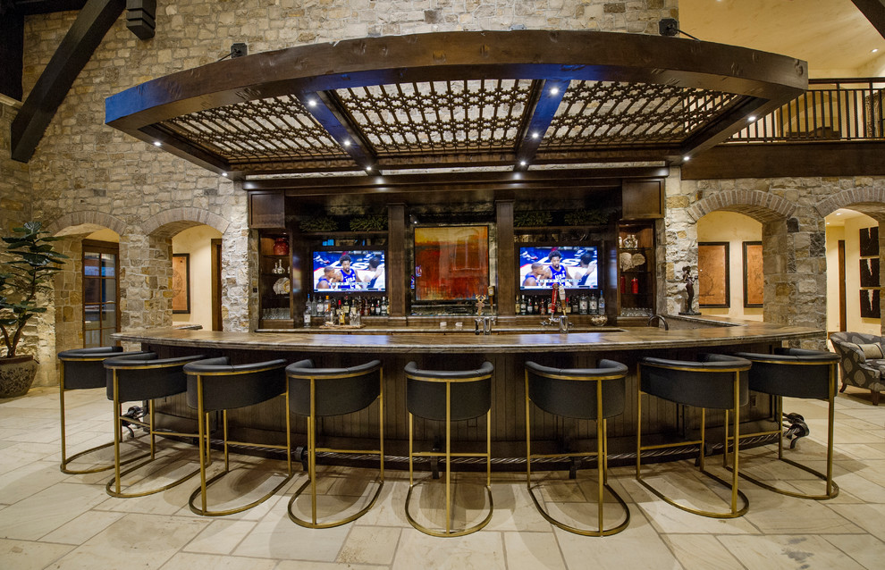 This is an example of an expansive country u-shaped home bar in Denver.