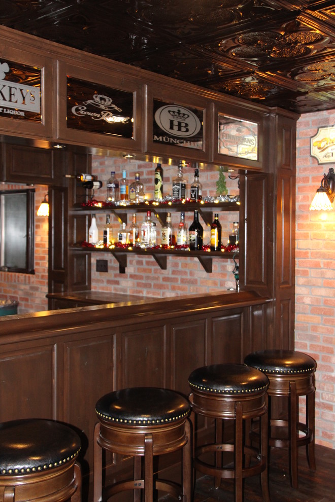 Photo of a traditional home bar in Minneapolis with raised-panel cabinets.