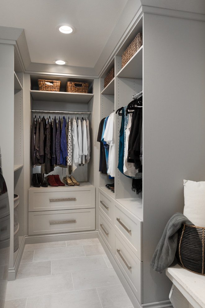 Design ideas for a mid-sized transitional walk-in wardrobe in Other with shaker cabinets, grey cabinets, porcelain floors and white floor.