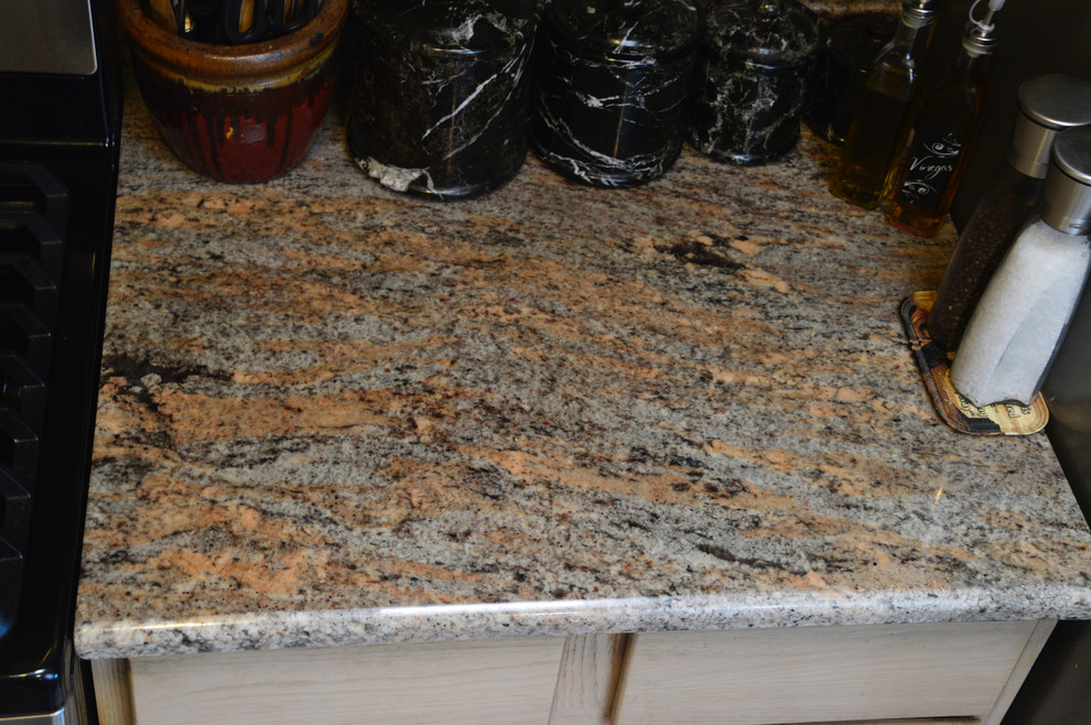 Example of a small mountain style single-wall ceramic tile enclosed kitchen design in Albuquerque with an undermount sink, granite countertops and no island