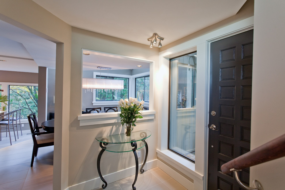 Photo of a contemporary entryway in Vancouver with grey walls, a single front door and a black front door.