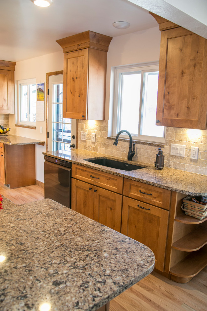 Example of a mid-sized mountain style galley medium tone wood floor and brown floor eat-in kitchen design in Denver with an undermount sink, shaker cabinets, medium tone wood cabinets, quartz countertops, gray backsplash, stone tile backsplash, black appliances, no island and brown countertops